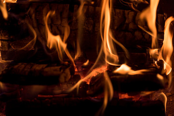 Fire flames in the fireplace. Closeup of burning wood.