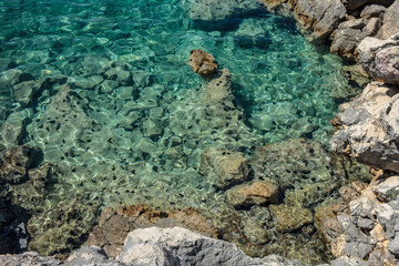 Fototapeta na wymiar Rocky coastline beach in Croatian island Pag with blue sea.