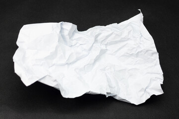 Single crumpled sheet of white paper