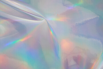 Rainbow halographic wrinkled foil background. Abstract pastel color background.