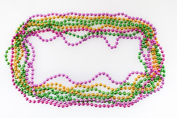 Three colors Mardi gras beads frame on white background