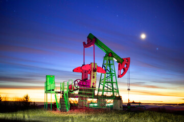 Oil production at night in the mountains