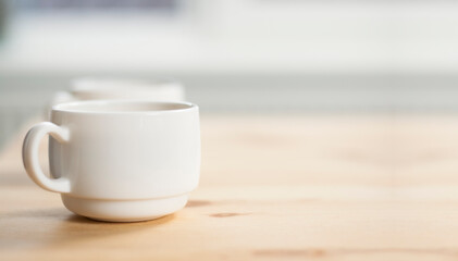 Cup of coffee on a wooden table. Breakfast morning