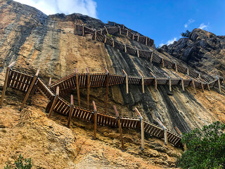 Vertiginous impressive hanging footbridges of Montfalcó. Wooden stairs built in the rock in the...