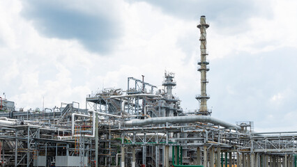 Industrial furnace and heat exchanger cracking hydrocarbons in factory on blue sky background,...