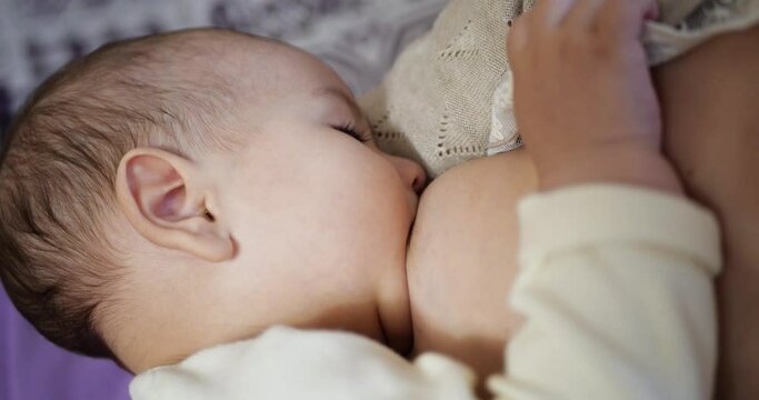 Woman breastfeeding newborn baby. Baby eating mother's milk. Concept of lactation infant