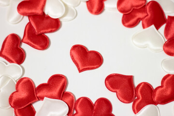 Small red and white hearts that are scattered on a white background.
