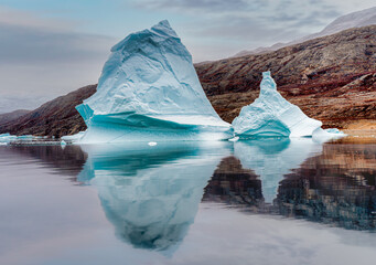 Massive dramatic icebergs with incredible sea reflections