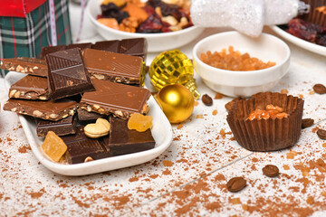 sweet food top view background for merry christmas or new year holiday decoration - chocolate candies, tangerines, cookies on white wood