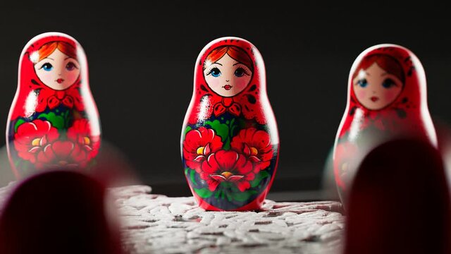 Matryoshka dolls placed in a circle. A camera follows one babushka after another