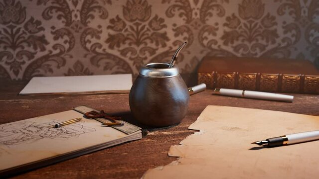 Traditional yerba mate on a vintage desk. Energy herbal drink. Gourd with straw