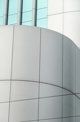 Modern abstract architecture 
Detail of aluminum walls contrasting with aquamarine tinted glass windows
