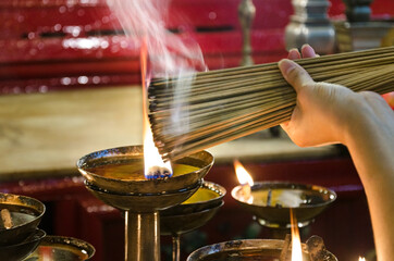Offering burning incense close-up
Big stack of ceremonial incense to pray for good things in life
