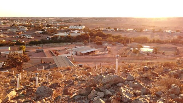 Sunset aerial view of Coober Pedy underground town in Australia from lookout cave at twilight in Coober Pedy city center. Located in Australian outback of South Australia.