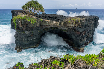The turbulent blue sea pounds a unique rocky structure in Apia,  Samoa