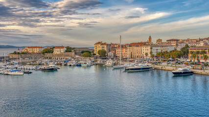 A great sunset harbor view with reflections on the sea from the city and the sky in Corsica, birthplace of Napoleon.