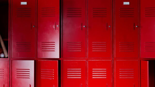 Abounded school hallway. Camera moving up and showing red lockers for students.