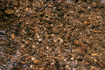 texture background of little rocks in a river