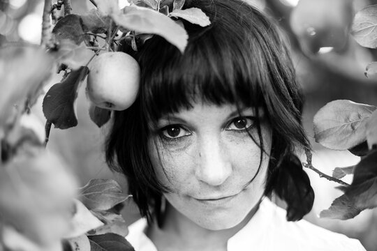 Portrait of young woman in an Apple orchard. Black and white photo.