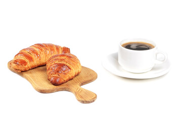 Croissants and cup of coffee isolated on a white background. Breakfast with Fresh pastry. Croissants on a cutting board.