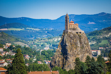 View of the Saint Michel d'Aiguilhe rock taken from the St Joseph Sanctuary in Espaly (Auvergne,...