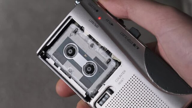Portable Retro Cassette Recorder in Hand Push on Rec to Record Interviews.