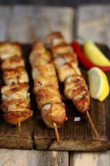 Juicy chicken skewers on wooden sticks.