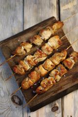 Juicy chicken skewers on wooden sticks.
