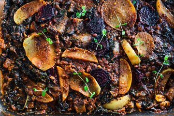 plant-based food,  vegan veggie roast with potatoes beetroot and kale as main ingredients