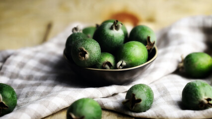 Fresh feijoa fruits in a bowl.