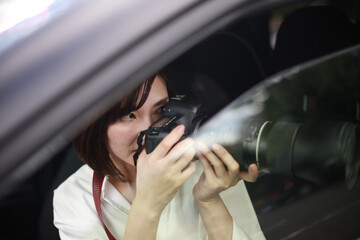 車内から写真を撮る女性