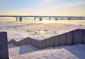 The descent from Michael's waterfront. Granite steps covered with snow, Oktyabrsky bridge in the...