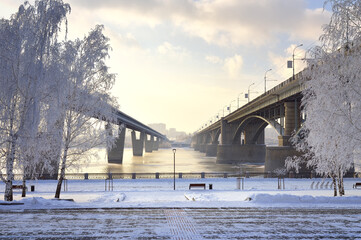 Michael's embankment in winter. Oktyabrsky bridge and metro bridge across the Ob lead to the Gorsky district