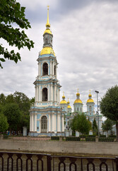 Fototapeta na wymiar Bell tower of St. Nicholas Sea Cathedral. Tall, slender tower with a spire in Baroque style on the embankment of the Kryukov kanala. Architecture of the XVIII century