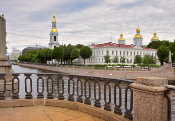 View from the Staro-Nikolsky bridge. Parapet of the Kryukov canal embankment, St. Nicholas Sea Cathedral with a bell tower and blue walls in the Russian Baroque style