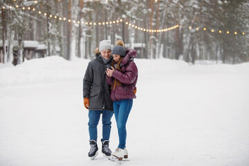 Fototapeta na wymiar Couple man and woman on the rink in winter.