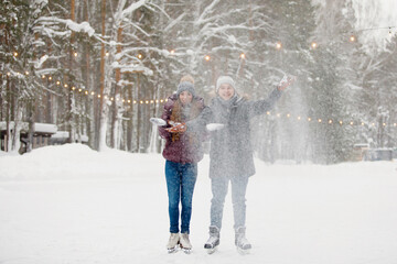 Couple man and woman at the winter rink.