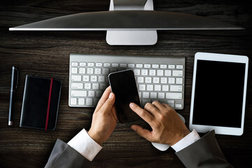 Top view.Business analysis and strategy concept. Businessman analyzing financial data on smartphone and laptop computer..