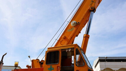 Hydraulic cylinder of a mobile crane. Hydraulic channel lifting mechanism on a large yellow truck...