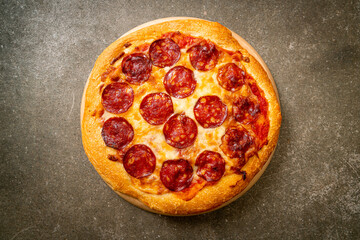 pepperoni pizza on wood tray