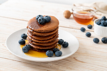 chocolate pancake stack with blueberry and honey