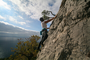 A young woman climbs in Crimea, Russia.