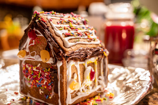 Homemade Gingerbread House With A Blurred Kitchen Background