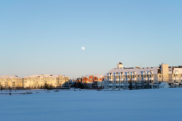 Residential Apartment blocks with frozen lake in foreground in winter