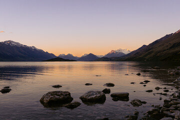 Dramatic sunset in Lake Wakatipu with the amazing view of snowy peaks. Otago, New Zealand