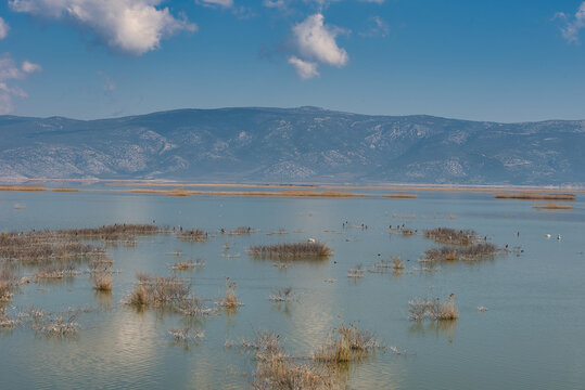 A majestic cloudscape over a calm Karla lake in Greece during the daytime