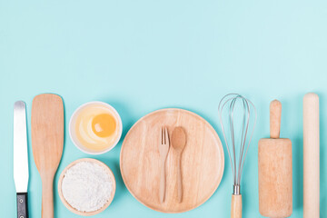 Kitchen utensils and food ingredients for bakery cooking on color background, Top view