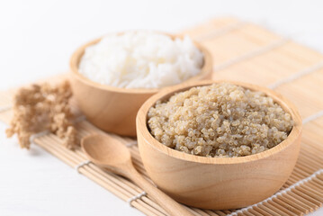 Cooked brown quinoa seeds and rice in a wooden bowl, Healthy vegan food