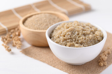 Cooked brown quinoa seeds and raw quinoa seeds in a bowl, Healthy vegan food