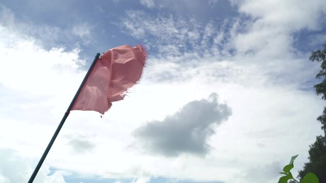 Red flag Alert, warning dangerous to swimming in sea. Red flag flying on beach with sound of winds and sea waves. in phuket thailand.